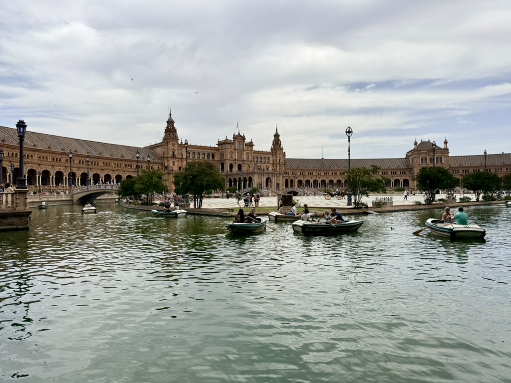Wide view of Plaza de España in Seville with rowboats on the canal