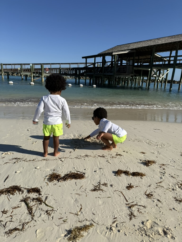 The boys exploring the empty stretch of beach beside the dock early in the morning