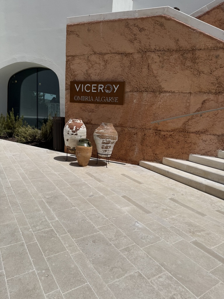 The Viceroy at Ombria Algarve entrance sign against a rammed-earth wall
