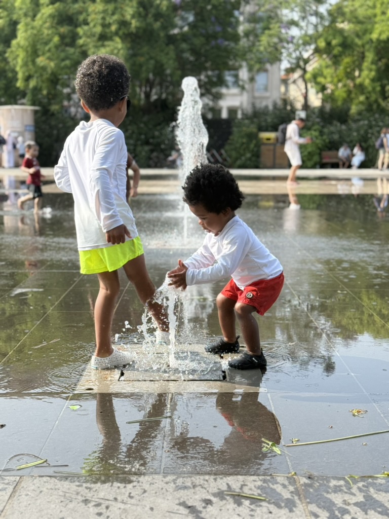 Two young boys playing in the fountains at Promenade du Paillon in Nice.