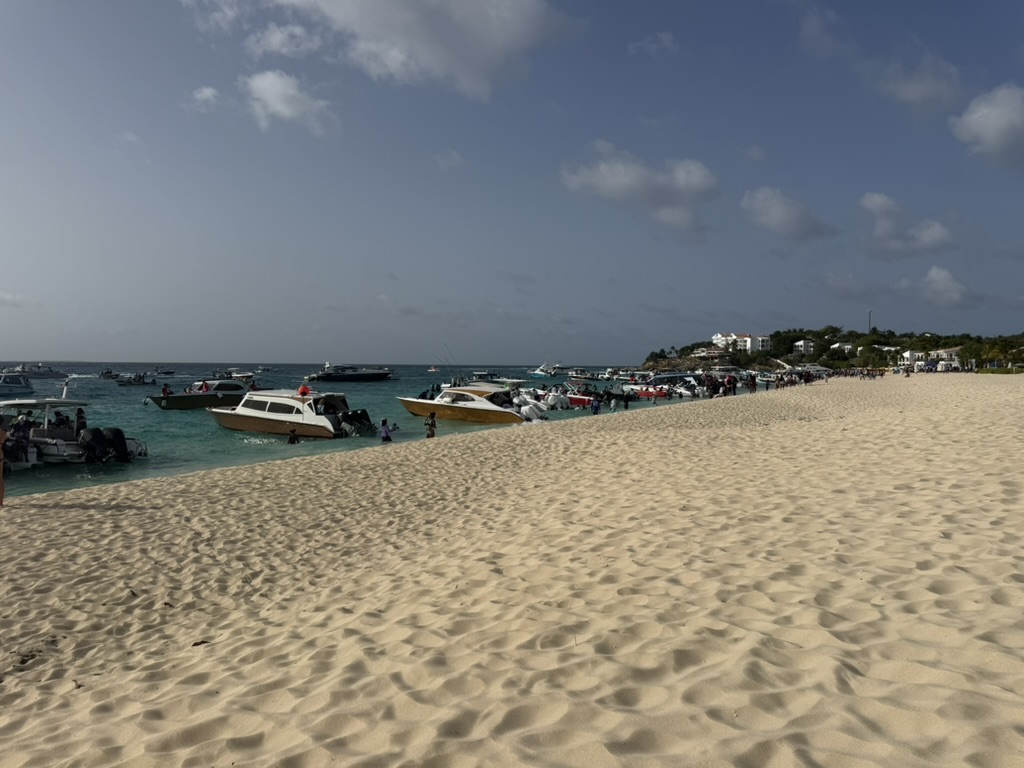 Dozens of powerboats pulled up along the shoreline with crowds gathered on the sand