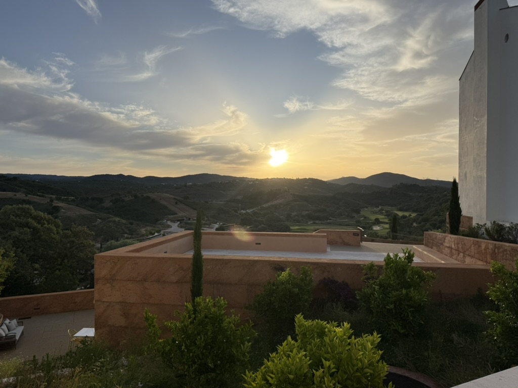Sunset over the Algarve hills and golf course seen from the resort terrace