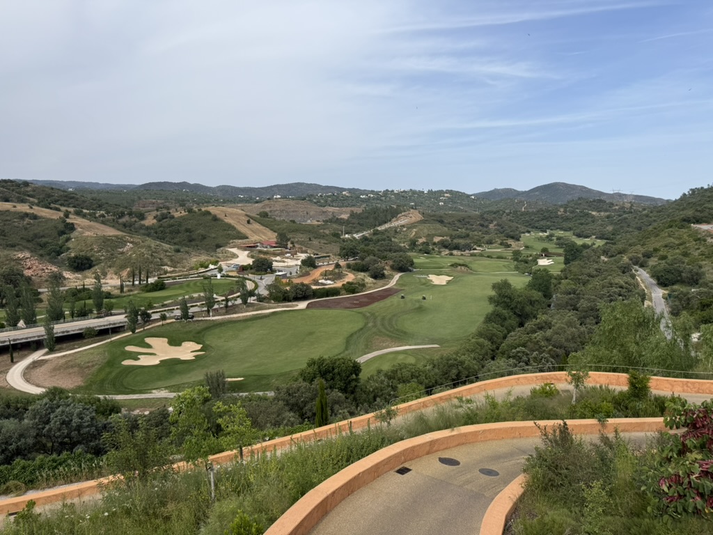 View over the green golf course and rolling Algarve countryside from the hillside road