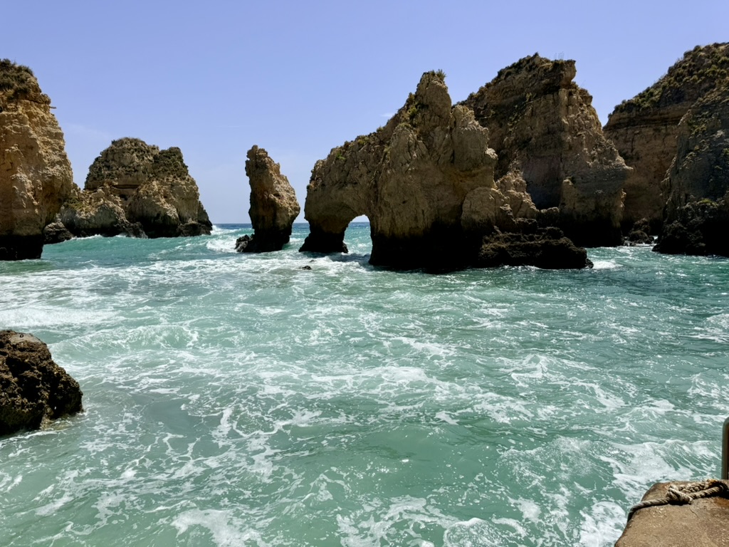 Golden cliffs and sea arches rising out of turquoise Atlantic water at Ponta da Piedade