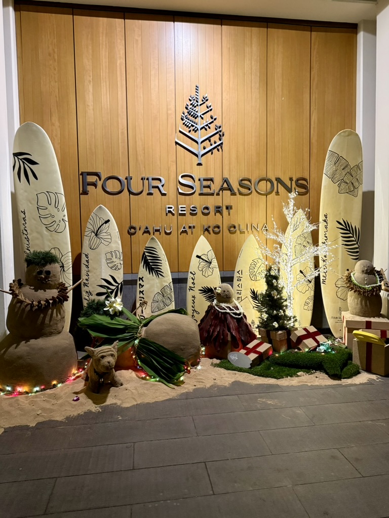 Holiday display of decorated surfboards and sand snowmen at the Four Seasons Resort Oahu at Ko Olina entrance